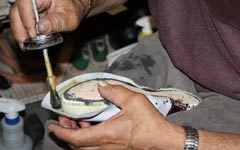 handmade white golf shoe being made